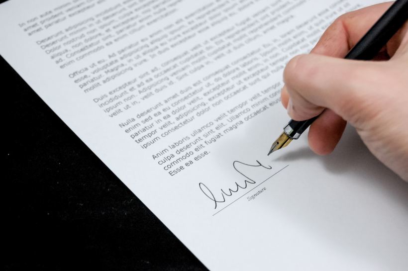 man signing contract
